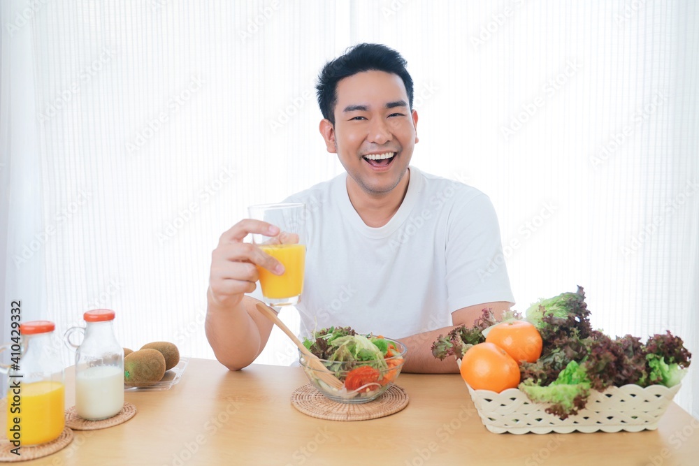 Smiling Asian man joyful with healthy food in the morning Smiling Asian man joyful with healthy food in the morning