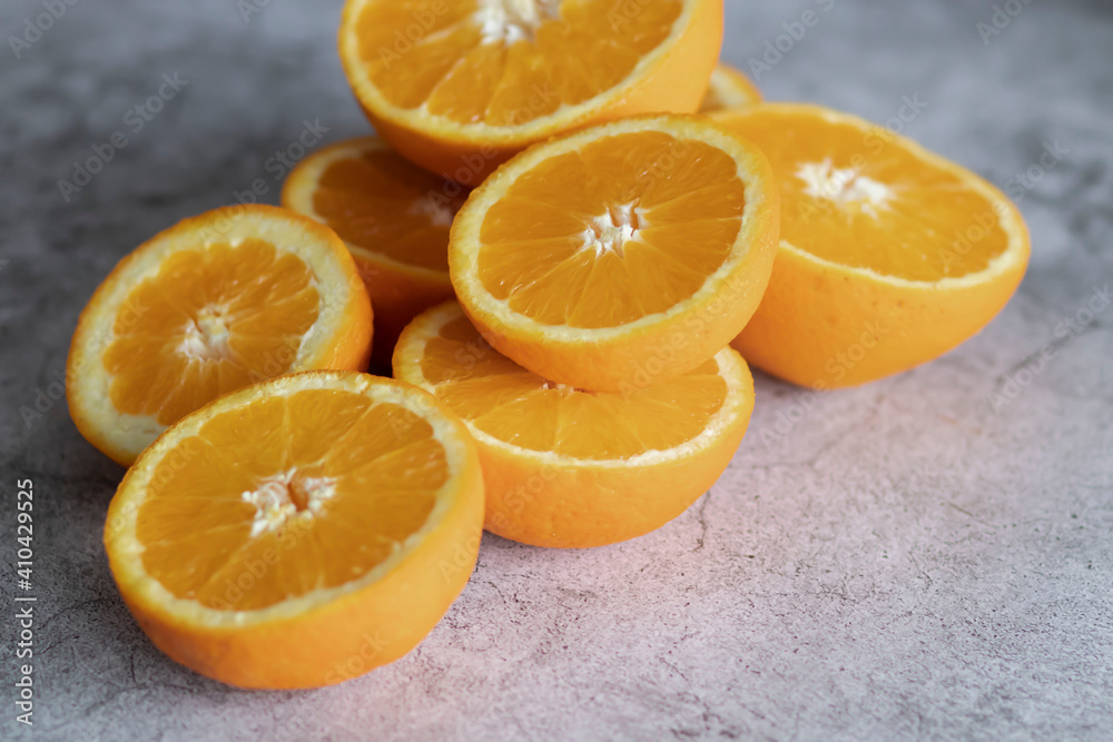 The orange halves are on the table. On a gray and white background. The orange halves are on the table. On a gray and white background.