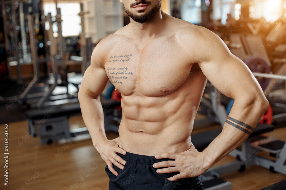 Close-up photo of muscular athletic young man bodybuilder fitness model rest after exercises in gym. Close-up photo of muscular athletic young man bodybuilder fitness model rest after exercises in gym.
