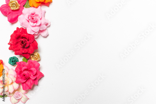 Frame made of rose flowers on white background. Top view with copy space. © Pataradon