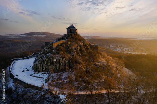 Salgo castle ruins in Hungary. Medieval fort ruins next to Salgobanya town.  Built in 13th century. Amazing aerial view in winter with snow covered. photo