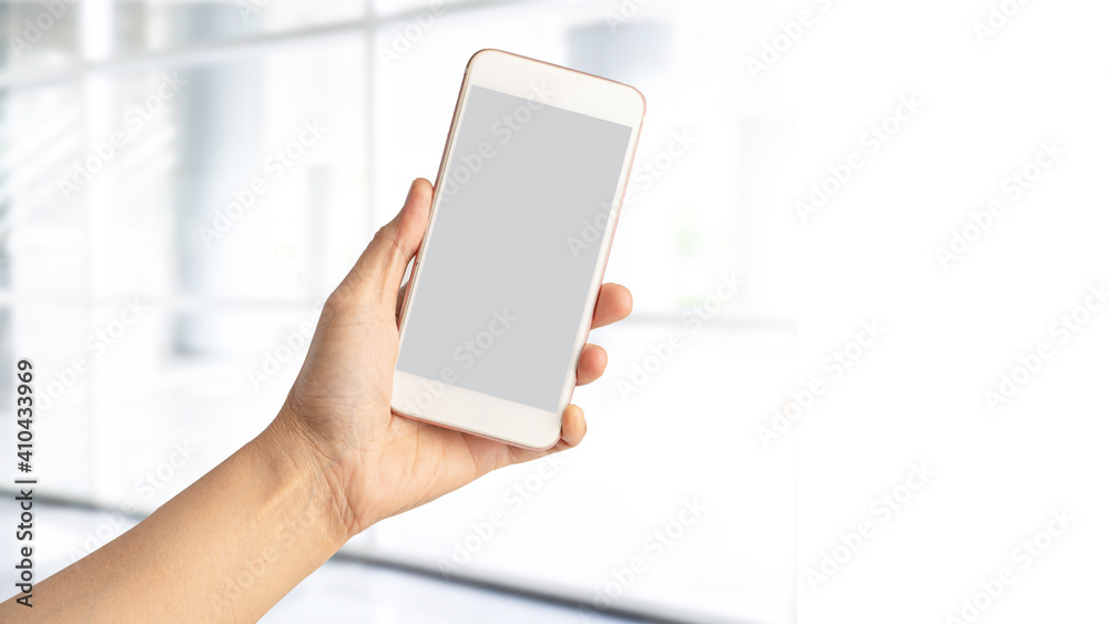 Lady woman hand holding mobile phone with copy space.