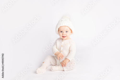 baby in a warm suit and hat on a white isolated background, space for text