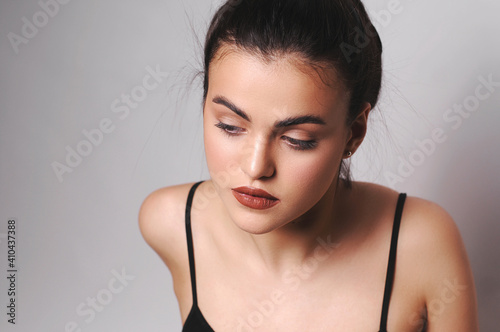 Young girl in a black top.Studio photography.