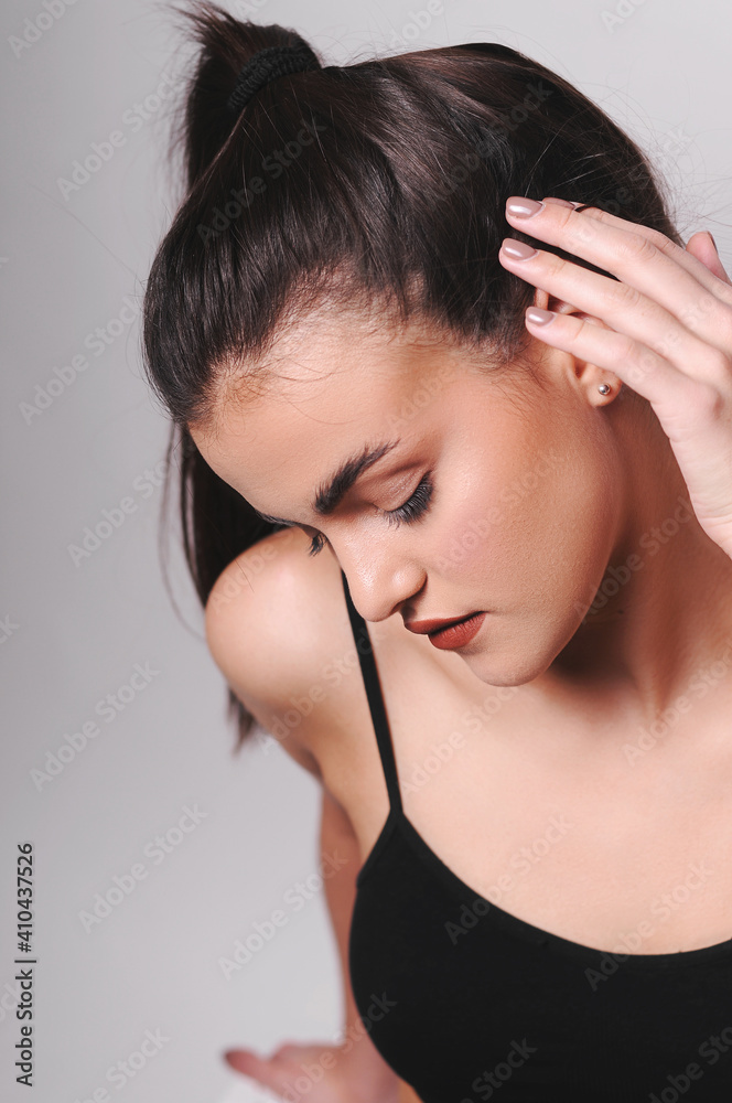 Young girl in a black top.Studio photography. Young girl in a black top.Studio photography.