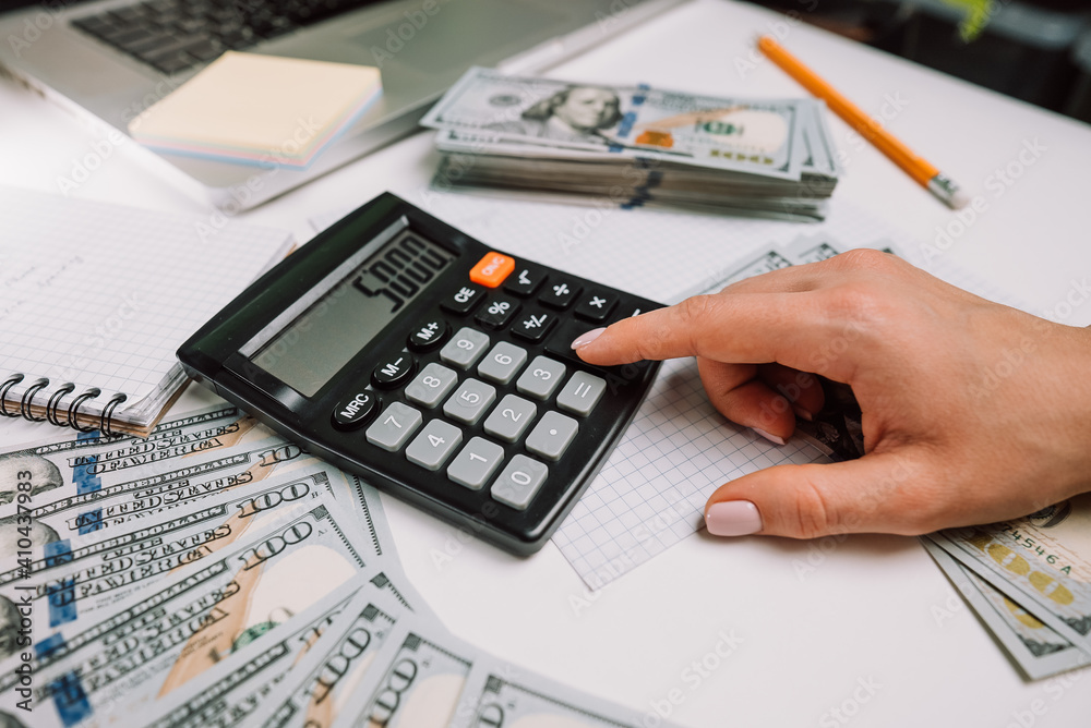 Close-up of old analog calculator. Young woman counts numbers on device, keeps track of money. Student does homework, teaching mathematics. Close-up of old analog calculator. Young woman counts numbers on device, keeps track of money. Student does homework, teaching mathematics.