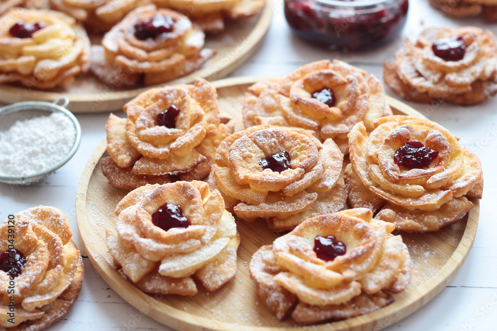 Carnival roses with jam and powdered sugar - traditional Polish cookies eaten during carnival and fat Thursday