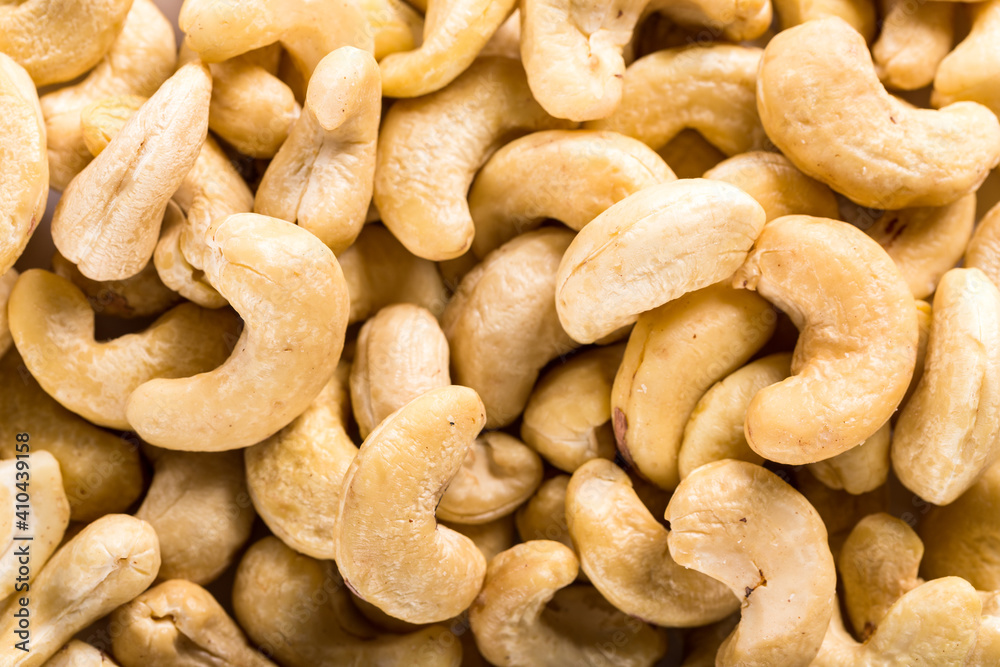 Background of big raw peeled cashew nuts, situated arbitrarily. Background of big raw peeled cashew nuts, situated arbitrarily.