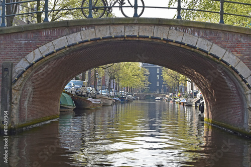 Looking through a bridge spanning a canal in Amsterdam