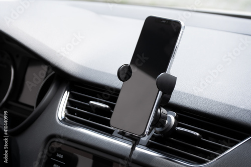 Universal mount holder for smart phones on dashboard photo