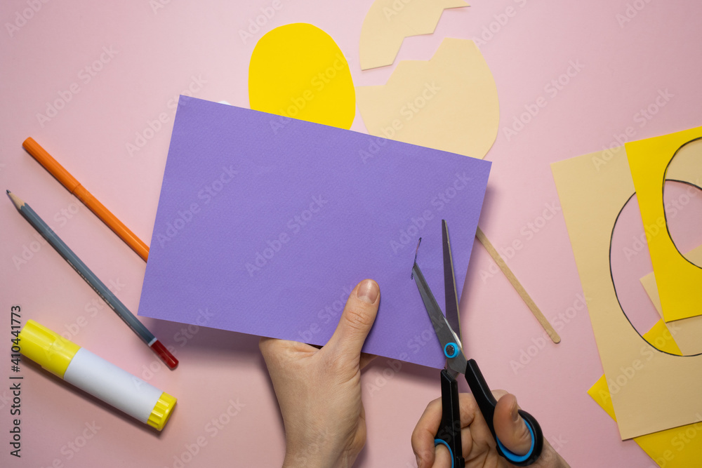 Fototapeta premium Easter greeting card in egg shape. How to make children's paper craft. Step 5. Simple creative art project. Step by step instructions. Homemade easy paper applications. DIY concept.