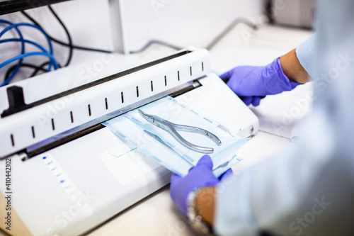 dental hygienist sterilizing clinical material