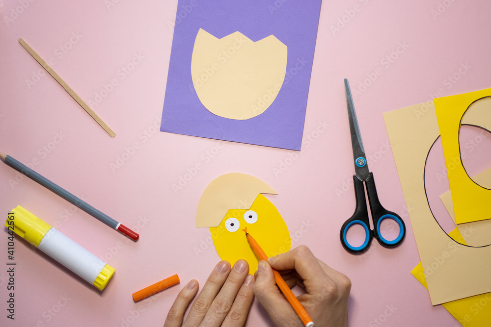 Fototapeta premium Easter greeting card in egg shape. How to make children's paper craft. Step 7. Simple creative art project. Step by step instructions. Homemade easy paper applications. DIY concept.