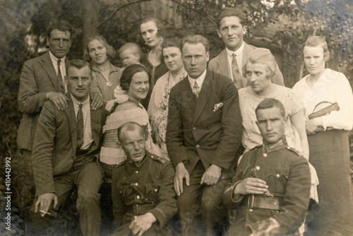 Latvia - CIRCA 1920s: Group photo of party guests. Some men in uniform. Vintage historical archive photo
