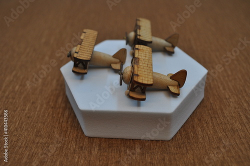 Close up creative shots of small wooden plane models handcrafted from wood, around 3cm X 2cm in size photo