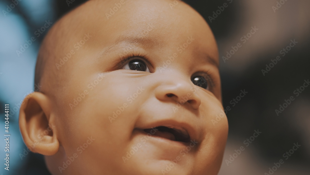 Portrait of adorable curious multiracial dark skin baby looking up. . High quality photo Portrait of adorable curious multiracial dark skin baby looking up. . High quality photo