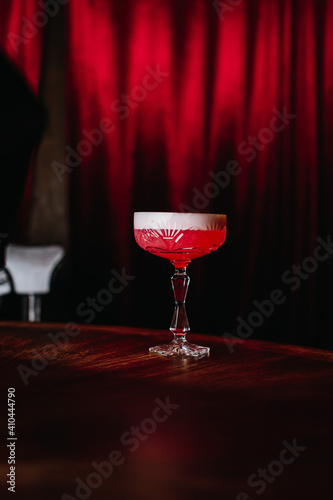 There is a red cocktail in the bar.