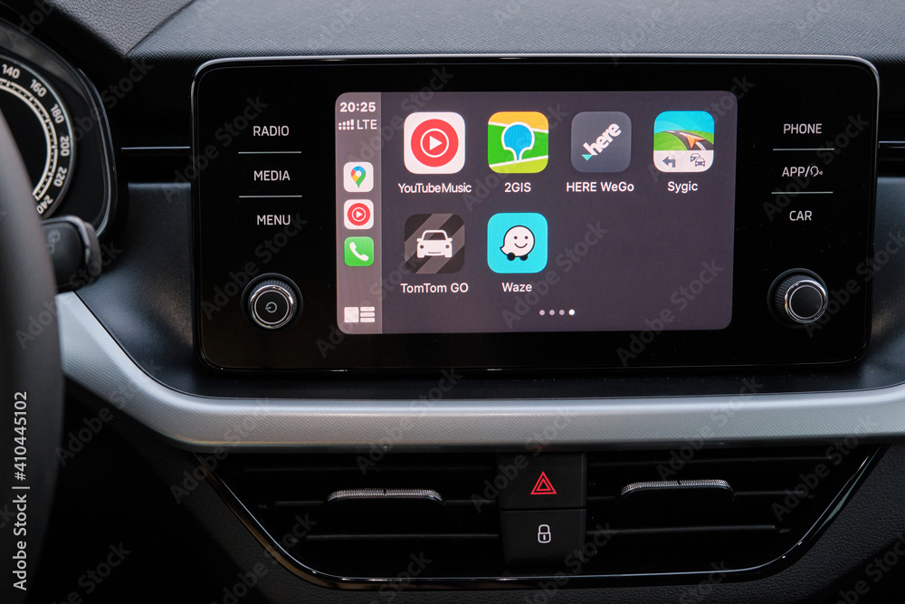 Apple CarPlay screen in the car dashboard. Youtube music, Waze, 2GIS
