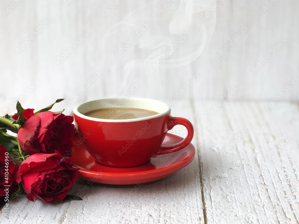 Coffee with cup and red roses on wooden floor and white background. Valentine concept.