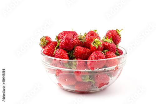 Fresh ripe delicious strawberries in a glass bowl on white background
