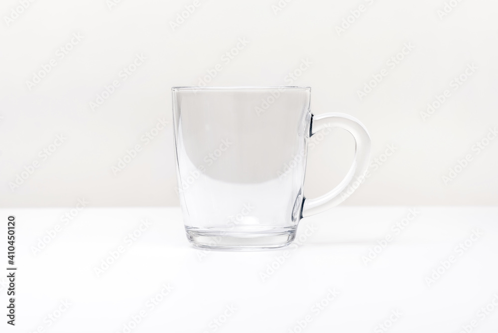 Empty glass cup with handle, isolated on white Empty glass cup with handle, isolated on white