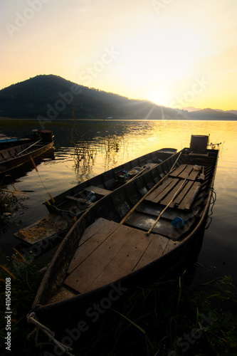 Fototapeta Naklejka Na Ścianę i Meble -  Rowing boat in a lake with sunset sky