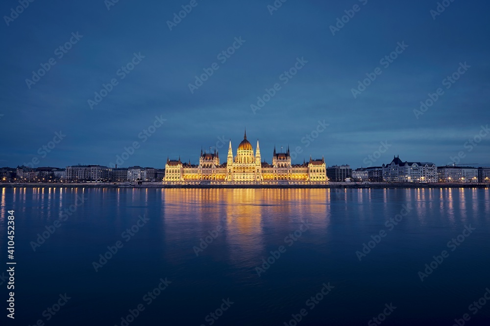 Reflection of illuminated Hungarian Parliament building in Danube River. Budapest skyline at dusk, Hungary.