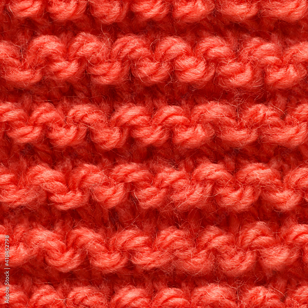 Red knitted fabric seamless pattern for borderless fill. Knitted fabric repeating pattern for background close up. Red knitted fabric seamless pattern for borderless fill. Knitted fabric repeating pattern for background close up.