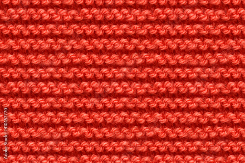 Red Knitwear Fabric Texture. Machine Knitting Texture Macro Snapshot. Knitted Background.