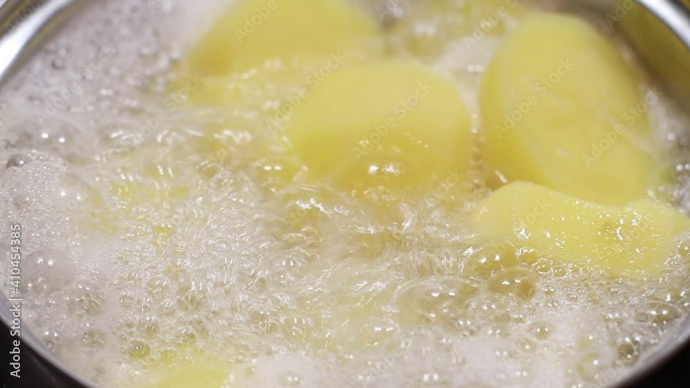 Pan of potatoes cooking in boiling water Pan of potatoes cooking in boiling water
