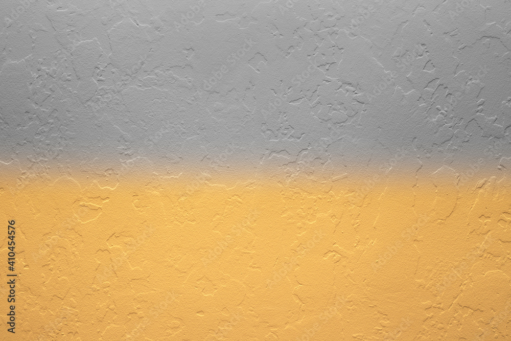 texture of decorative plaster of gray and yellow color with a gradient on the wall. Repair and decoration of premises. Place for text