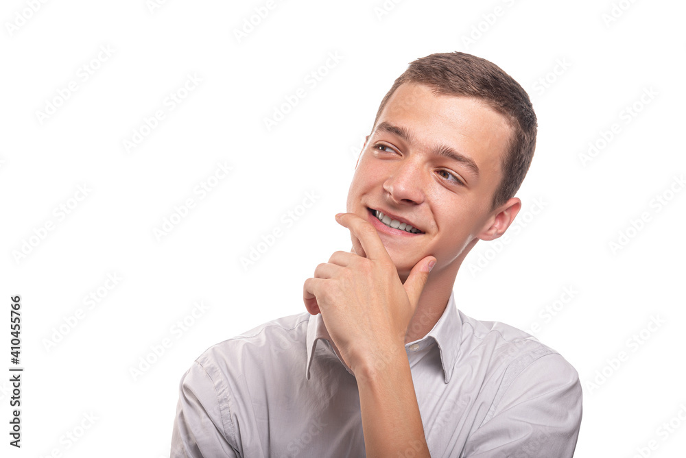 A young man in a shirt is thinking about something pleasant. Isolated on white background. A young man in a shirt is thinking about something pleasant. Isolated on white background.