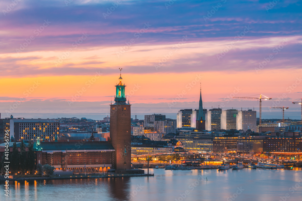 Stockholm, Sweden. Scenic Skyline View Of Famous Tower Of Stockholm City Hall And St. Clara Or Saint Klara Church. Popular Destination Scenic View In Sunset Twilight Dusk Lights. Evening Lighting