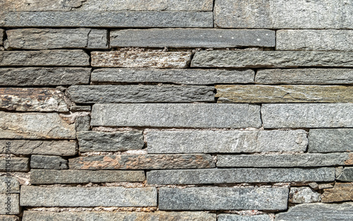 rough grey slate stone wall closeup  textured pattern background