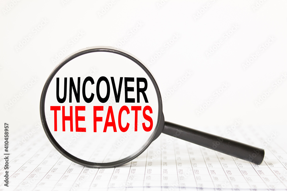 words UNCOVER THE FACTS in a magnifying glass on a white background. business concept words UNCOVER THE FACTS in a magnifying glass on a white background. business concept