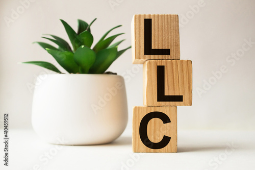 a word LLC on wooden cubes. business concept. business and Finance