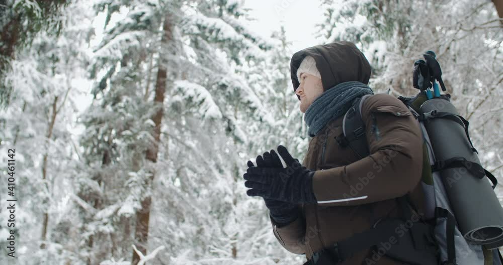 custom made wallpaper toronto digitalHandheld portrait young caucasian traveler relaxing in winter forest during snowfall. Happy hiker looks around enjoying trek in snowy woods. Snow flakes falling down. Concept of human and nature