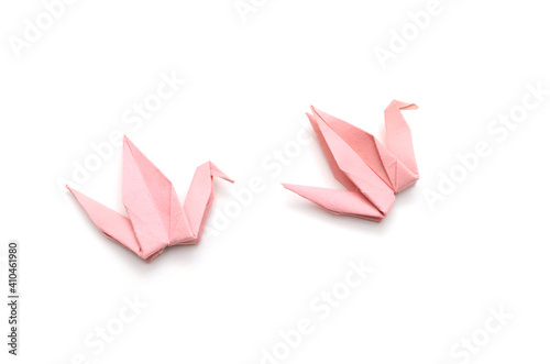 Two pink origami cranes isolated on white background.
