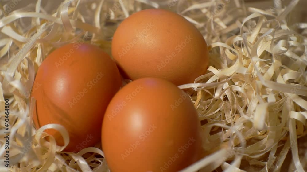 straw nest with a three chicken eggs.Close-up.view from above. straw nest with a three chicken eggs.Close-up.view from above.