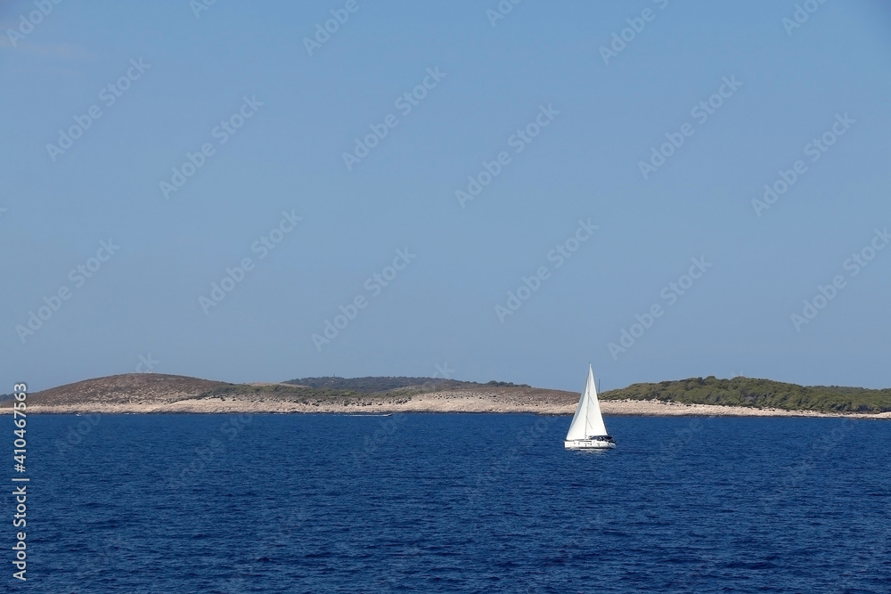 Sailing boat near island in Croatia. Beautiful Mediterranean landscape.
