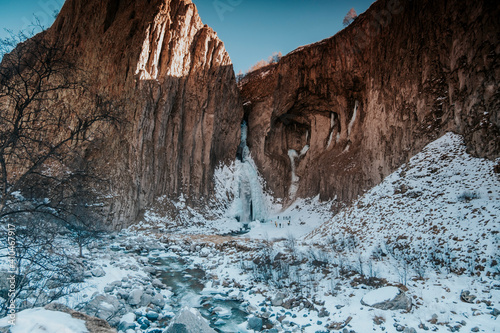 Photo of the Jily Su waterfall in winter. Landscape of mountains with a waterfall.  photo
