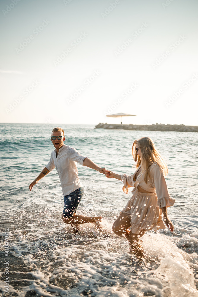 Romantic couple posing at stone beach Stock Photo by ©AnnHaritonenko  75375857