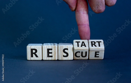 Rescue and restart symbol. Businessman hand turns cubes and changes the word 'rescue' to 'restart'. Beautiful grey background. Business and rescue - restart concept. Copy space.