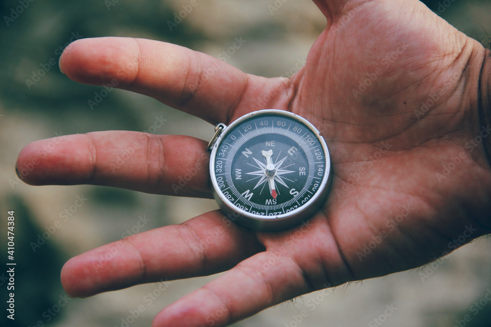 compass in open hand of man