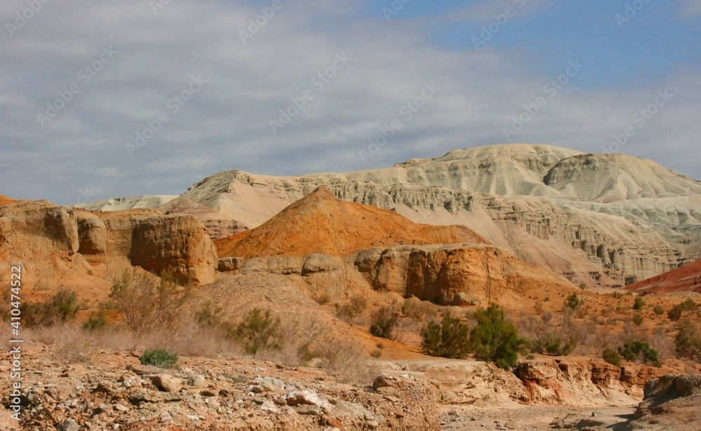 Aktau Mountains on sunrise. Beautiful landscape of colorful mountains in desert. Nature reserve Altyn Emel. Kazakhstan Aktau Mountains on sunrise. Beautiful landscape of colorful mountains in desert. Nature reserve Altyn Emel. Kazakhstan
