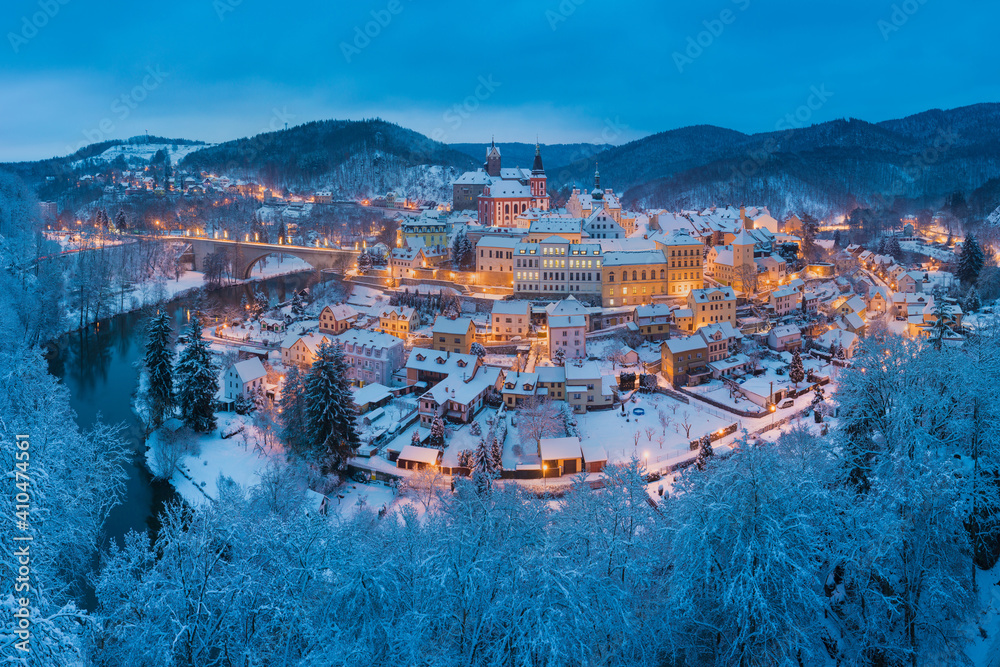 Stunning scenic view of beautiful cityscape of medieval Loket nad Ohri town with Loket Castle gothic style on massive rock, colorful buildings during winter season, Karlovy Vary Region, Czech Republic