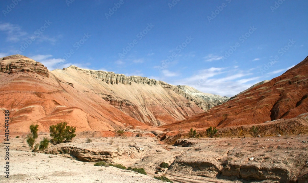 Aktau Mountains on sunrise. Beautiful landscape of colorful mountains in desert. Nature reserve Altyn Emel. Kazakhstan. Panorama with copy space