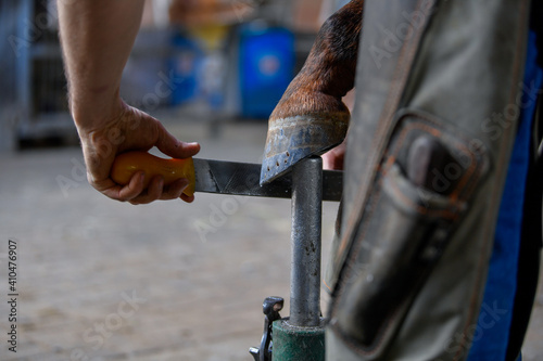 A farrier adjusting a horseshoe 