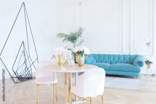 chic spacious light room in an old mansion in the classical style of the 19th century with a high ceiling decorated with stucco on white walls