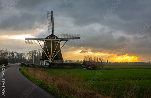 Traditional dutch windmill during dramatic sunset in Amsterdam south
